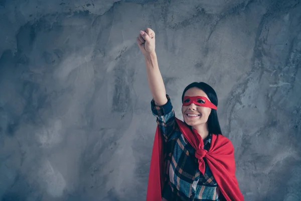 Close-up cropped portrait of her she nice-looking lovely cute charming attractive mysterious cheerful cheery lady wearing hero look outfit raising hand up isolated over grey concrete wall — Stock Photo, Image