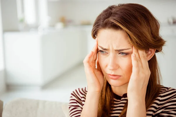 Close up photo beautiful she her lady arms hold head look side terrible suffer pain displeased grinning wear jeans striim striped pullover clothes bright comfort flat house living room indoors — стоковое фото