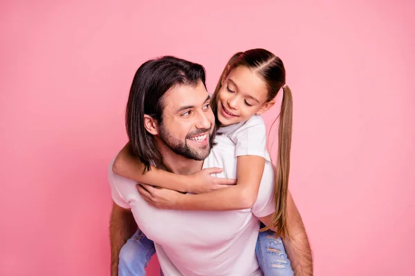 Close up photo beautiful adorable she her little lady he him his daddy dad hold little princess piggyback hands arms funny funky wear casual white t-shirts denim jeans isolated pink bright background — Stock Photo, Image