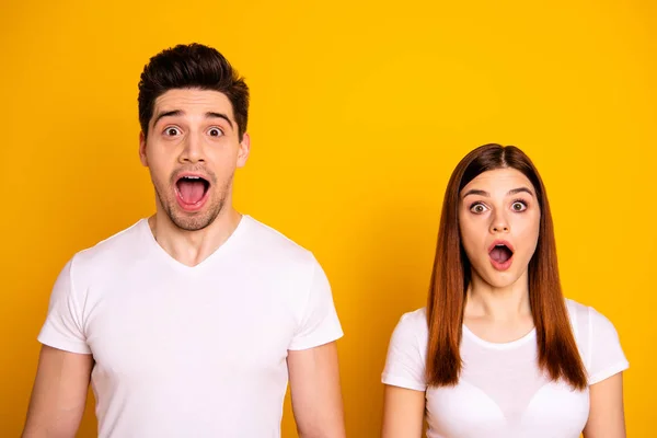 Close up photo two cool amazing beautiful she her he he him his couple standing side by side open mouth eyes incredible success wear casual white t-shirts outfit clothes isolated yellow background — Stockfoto