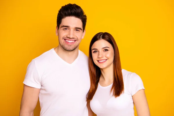 Close up photo funny amazing beautiful she her he him his guy lady standing hugging sincere beaming smile easy-going best fellows buddies wear casual white t-shirts outfit isolated yellow background — Stock Photo, Image