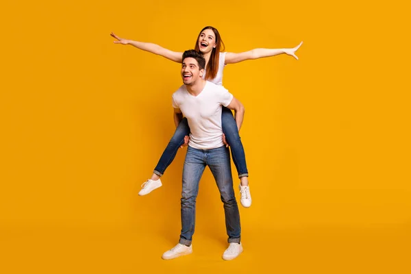 Full length body size view portrait of his he her she two nice attractive playful cheerful optimistic dreamy people wife husband having fun isolated over vivid shine bright yellow background — Stock Photo, Image