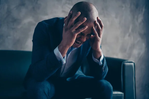 Portrait of nice stylish classy guy wearing jacket suit executive director top manager ceo boss chief financier sitting on couch crying grief shout yell scream at workplace workstation concrete wall — Stock Photo, Image