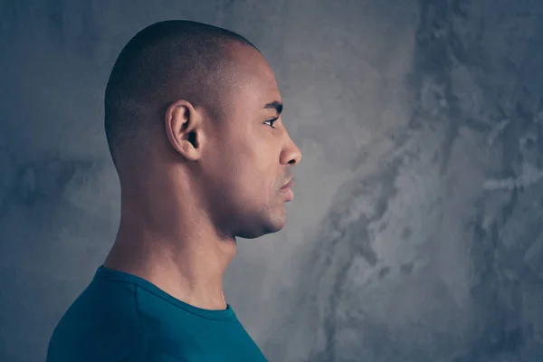 Close-up profile side view portrait of his he nice attractive strong character feature guy wearing casual trendy blue t-shirt isolated over gray industrial concrete wall — Stock Photo, Image