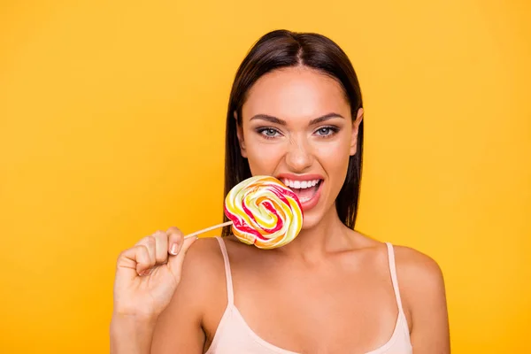 Close up photo beautiful she her lady you not you when hungry addicted sweets person big lolly pop wooden stick rude behavior biting wear casual pastel tank-top isolated yellow bright background — Stock Photo, Image