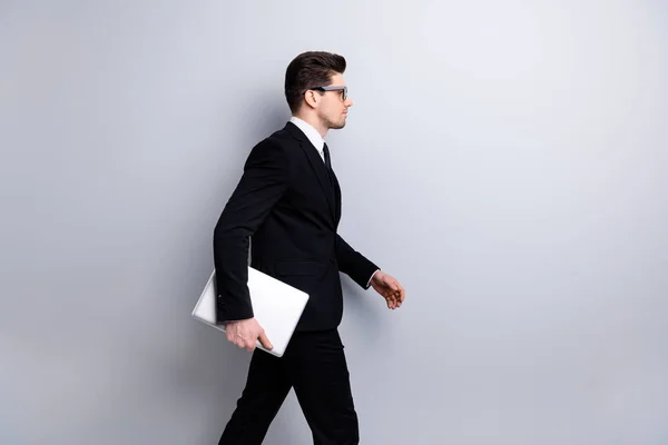 Profile side view portrait of his he nice imposing elegant classy chic attractive confident guy carrying in hands laptop marketing vacancy recruiting office startup isolated over light gray background — Stock Photo, Image