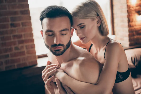 Close up side profile photo two people partners she her lady eyes closed whisper ear ear words touch hands him his handsome chest wife husband celebrate valentine day piggy back carry house room indoors — Fotografia de Stock