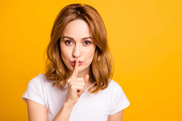 Close up photo beautiful amazing she her foxy lady hold arm hand index finger mouth lips ask stop talking tell speak say secrecy information wear casual white t-shirt isolated yellow background