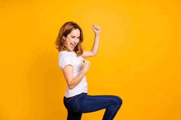 Portrait of nice charming lovely lady shout yeah fan have fortune luck celebrate content delighted raise fists arms hands dressed modern denim jeans clothing isolated yellow background — Stock Photo, Image