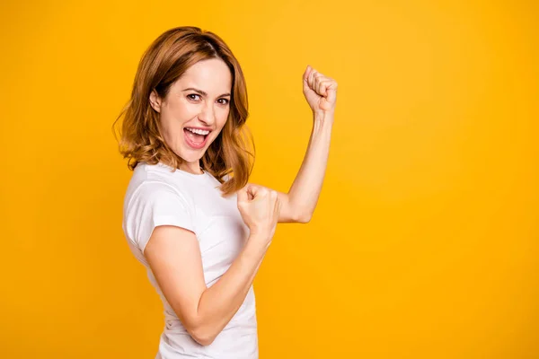 Portrait of nice charming lovely youngster people shout yeah fan have fortune luck celebrate content delighted raise fists arms hands dressed modern denim jeans clothing isolated yellow background — Stock Photo, Image