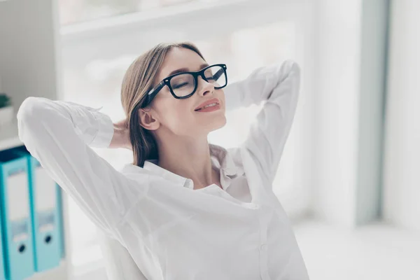 Close up photo beautiful she her lady hands behind head receiver online currency operator business start up eyes closed toothy eyewear yeglasses sit bright office wear specs formal-wear white shirt — Foto Stock