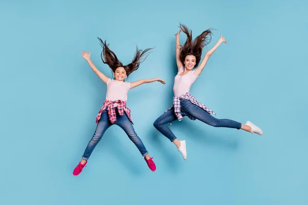 Full length body size view portrait of two nice attractive cheerful cheery careless carefree healthy straight-haired girls having fun rejoicing isolated on bright vivid shine blue turquoise background — Stock Photo, Image