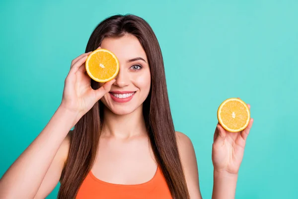Close up photo beautiful amazing her she lady hold arms hide one eye citrus useful slices products advertising nutrition freshness wear casual orange tank-top isolated bright teal turquoise background