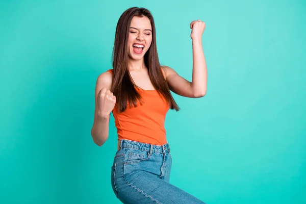 Close up side profile photo beautiful screelling yeah her she lady arms hands fists raised champion football competition wear casual orange tank-top jeans denim isolated bright teal turquesa fundo — Fotografia de Stock