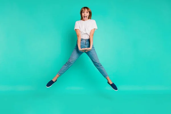 Full length body size photo beautiful she her lady carefree childish weekend vacation jump high arms hands together achievement wear casual jeans denim white t-shirt isolated teal background — Stock Photo, Image