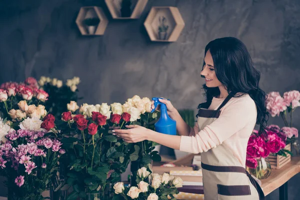 Close up side profile photo beautiful adorable she her lady many roses vases retail seller assistant hands arms check flowers condition pulverize water opening service small flower shop room indoors