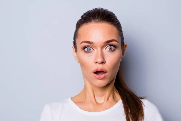 Close up photo beautiful amazing pretty she her lady big great eyes full fear staring stupor open mouth unexpected news epic fail lost loser wear casual white t-shirt isolated grey background Stock Picture