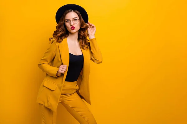 Portrait of her she nice charming cute attractive lovely winsome sweet fashionable chic cheerful wavy-haired lady wearing yellow jacket sending kiss isolated on bright vivid shine orange background — Stock Photo, Image