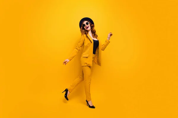 Full length side profile body size photo beautiful amazing funky she her lady walking down street perfect look tourism traveler wear specs formal-wear costume suit isolated yellow bright background — Stock Photo, Image