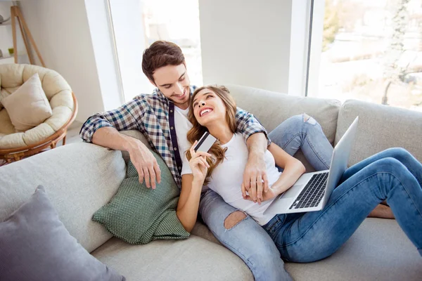 Portrait of her she his he two person nice attractive lovely cheerful positive guy lady sitting on cozy comfort divan using wireless instant pay in light white style interior living room house — Stock Photo, Image