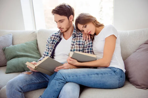 Portrait of his he her she nice-looking attractive cute charming focused concentrated calm peaceful couple morning sitting on cosy divan in light white style interior living room house indoors — Stock Photo, Image