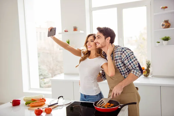 Close up side profile photo two people beautiful he his macho she her lady telephone hands make take selfies make first breakfast dishes bonding apartments flat bright white kitchen room indoors — стоковое фото