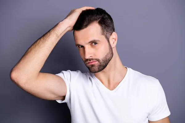Close up photo amazing he him his macho perfect appearance touch arm hand groomed head haircut stylist visit not smiling calm look mirror shower wear casual white t-shirt isolated grey background — Stockfoto