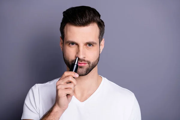 Close up photo amazing he he he he his macho hairless process buy buyer new hand novty ready remove nose ear hair with help little comfy trimmer wear casual white t-shirt isolated grey background — Foto de Stock