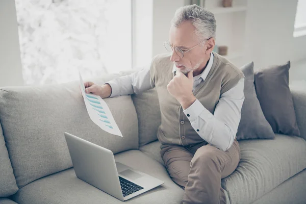 Close up side profile photo amazing he him his aged man thoughtful hand arm notebook search check information charts stats wear white shirt waistcoat pants cozy divan flat house living room indoors — Stock Photo, Image