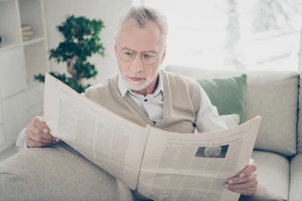 stock image Close up photo amazing he him his aged man arms hands fresh press newspaper political media wear specs white shirt waistcoat pants sit cosy comfort bright flat house living room indoors