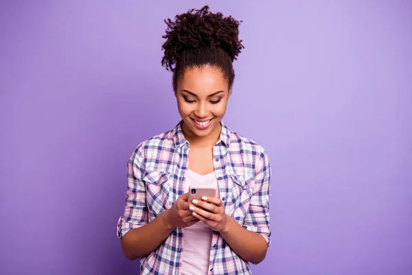 Portrait focused interested satisfied youth use modern technology blog blogger check social network account check read news beautiful plaid shirt stylish beautiful top-knot isolated purple background
