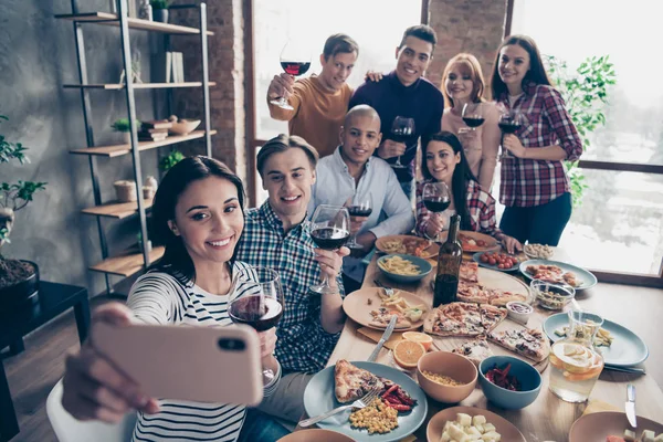 Close up photo friendly event together diversity different race guys raise glasses red beverage telephone make take tradition selfies sit table shirts sweater pullover loft cafe restaurant indoors — Stock Photo, Image