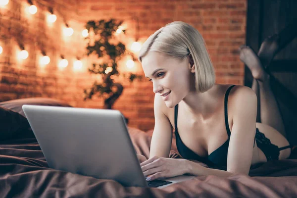 Close-up portrait of her she nice sweet chic groomed stunning gorgeous attractive feminine lovely lovable cheerful lady lying on bed chatting with boyfriend in loft brick industrial style interior — Stock Photo, Image