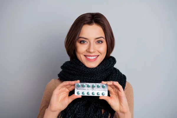 Close-up portrait of her she nice attractive lovely charming cute cheerful cheery girl holding in hands showing meds isolated over gray pastel background — Stock Photo, Image