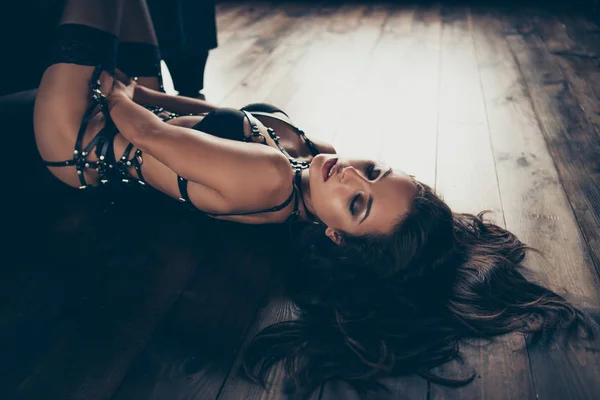 Profile side view portrait of dreamy mysterious magnificent charming attractive glamorous sportive figure lady wearing swordbelt teasing lying on floor enjoying mood closed eyes at loft interior wood — Stock Photo, Image