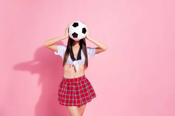 Photo of faceless lady cheerleader hold hands hide face soccer ball wear red short skirt white top isolated pink background