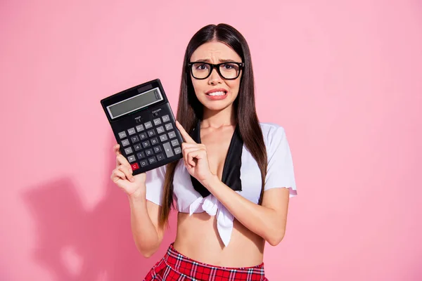 Photo of pretty lady hold calculator spend salary have no money for living wear white top short skirt isolated pink background