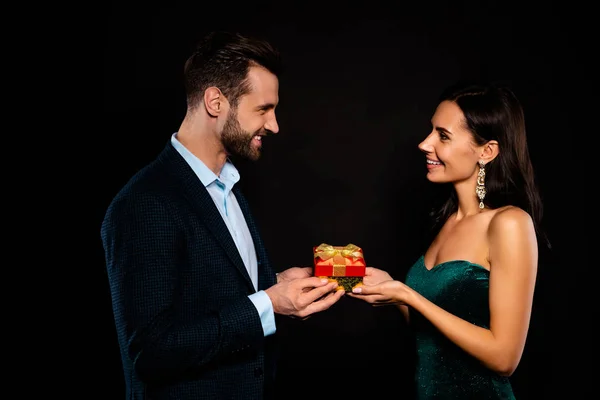 Profile side view portrait of nice lovable attractive lovely luxurious fascinating cheerful dreamy two person giving receiving expensive package rich wealthy guy isolated over black background — Stock Photo, Image