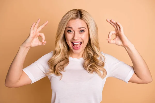 Close-up portrait of her she nice-looking attractive lovely cheerful cheery glad optimistic wavy-haired lady showing double ok-sign isolated over beige pastel background — Stock Photo, Image