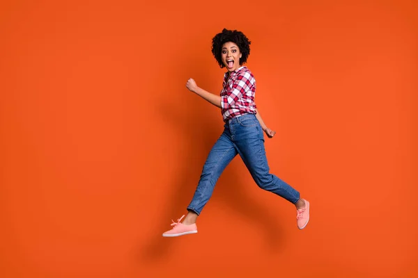 Teljes test oldalán fotó izgatott jumping nagy hölgy kiabál hangos eladó kedvezmény vásárlás kopás alkalmi ruhák felszerelés elszigetelt narancssárga háttér — Stock Fotó