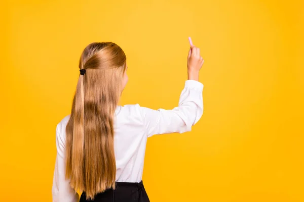 Rear back behind view portrait of nice attractive genius intellectual straight-haired pre-teen girl nerd writing message isolated on bright vivid shine yellow background — Stock Photo, Image