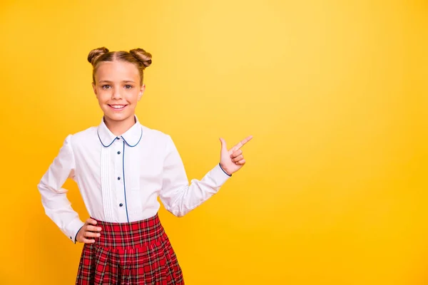 Portrait of her she nice-looking attractive lovely cheerful cheery confident pre-teen girl in white shirt pointing aside advert ad copy space isolated on bright vivid shine yellow background — Stock Photo, Image