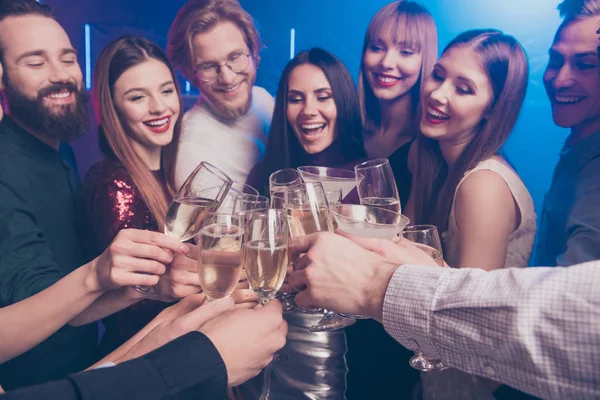 Cropped close-up portrait of nice chic winsome adorable glamorous luxury attractive fashionable gorgeous cheerful glad ladies and guys having fun clinking wineglasses sparkles at fogged lights
