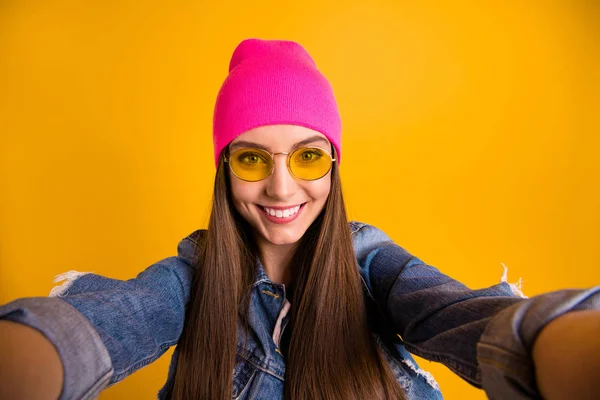 De cerca foto hermosa increíble ella su señora elegante hacer tomar selfies alegremente radiante sonrisa amigable adolescente milenario desgaste especificaciones casual jeans denim chaqueta rosa sombrero aislado fondo amarillo aislado —  Fotos de Stock