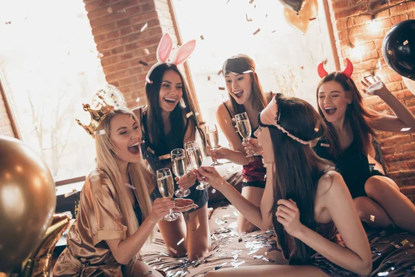 Nice cool feminine sweet winsome fascinating attractive lovely royal overjoyed cheerful group ladies sitting on bed having fun time in golden decorated loft industrial style interior room house — Stock Photo, Image