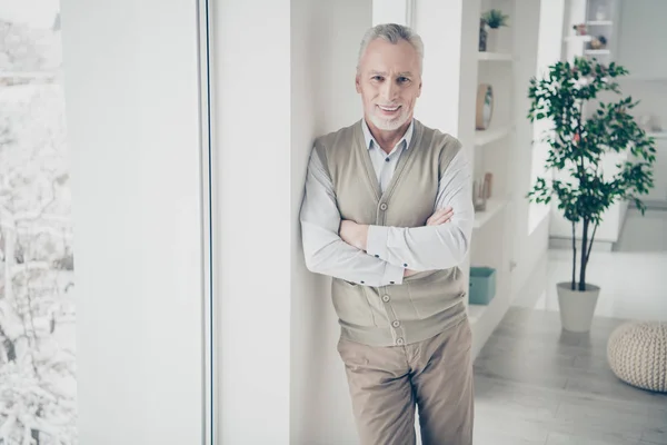 Close up foto incrível manager he him his aged man arms crossed bossy chief look self-confident wear white shirt waistcoat pants stand lean window comfort bright flat house living room indoors — Fotografia de Stock