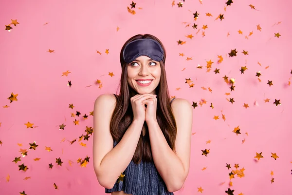 Close up photo beautiful amazing she her lady hands hold head chin glitter gold stars falling down enjoy overjoyed wear blue silky sleeping suit costume mask isolated pink background — стоковое фото