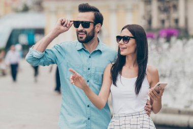 Portrait cute lovely people fellow fellowship hold hand cellphone smartphones mart cell phone mobile sign index bearded fingers eyewear eyeglases stroll shirt blue denim jeans white skirt dress spring clipart