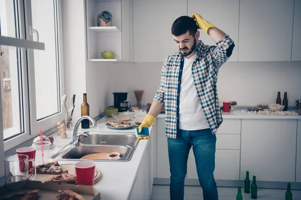 Portrait of his he nice attractive minded annoyed bearded guy wearing checked shirt mess chaos around maid service in modern light white interior style kitchen indoors — Stock Photo, Image