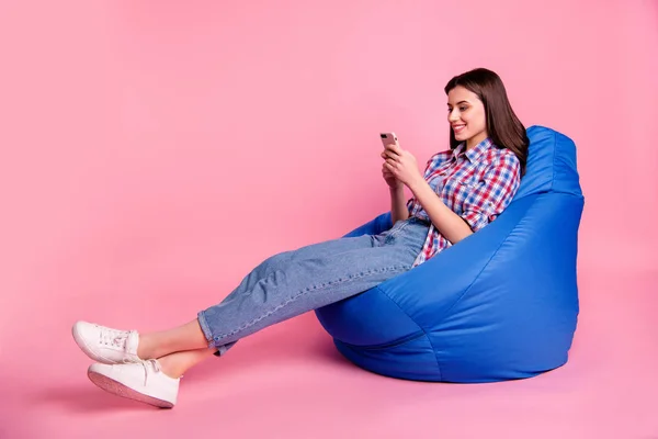 Perfil vista lateral foto bonito atraente adolescente segurar mão moderna tecnologia seguir blog usar usuário tempo livre jeans sneakaers branco pernas longo elegante verificado camisa isolado rosa fundo — Fotografia de Stock